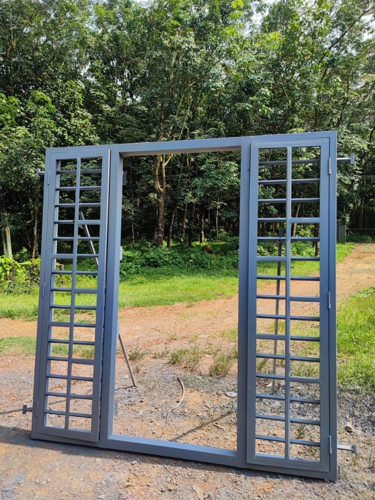 Grey steel door and window frame standing open on a project site, ready to fix